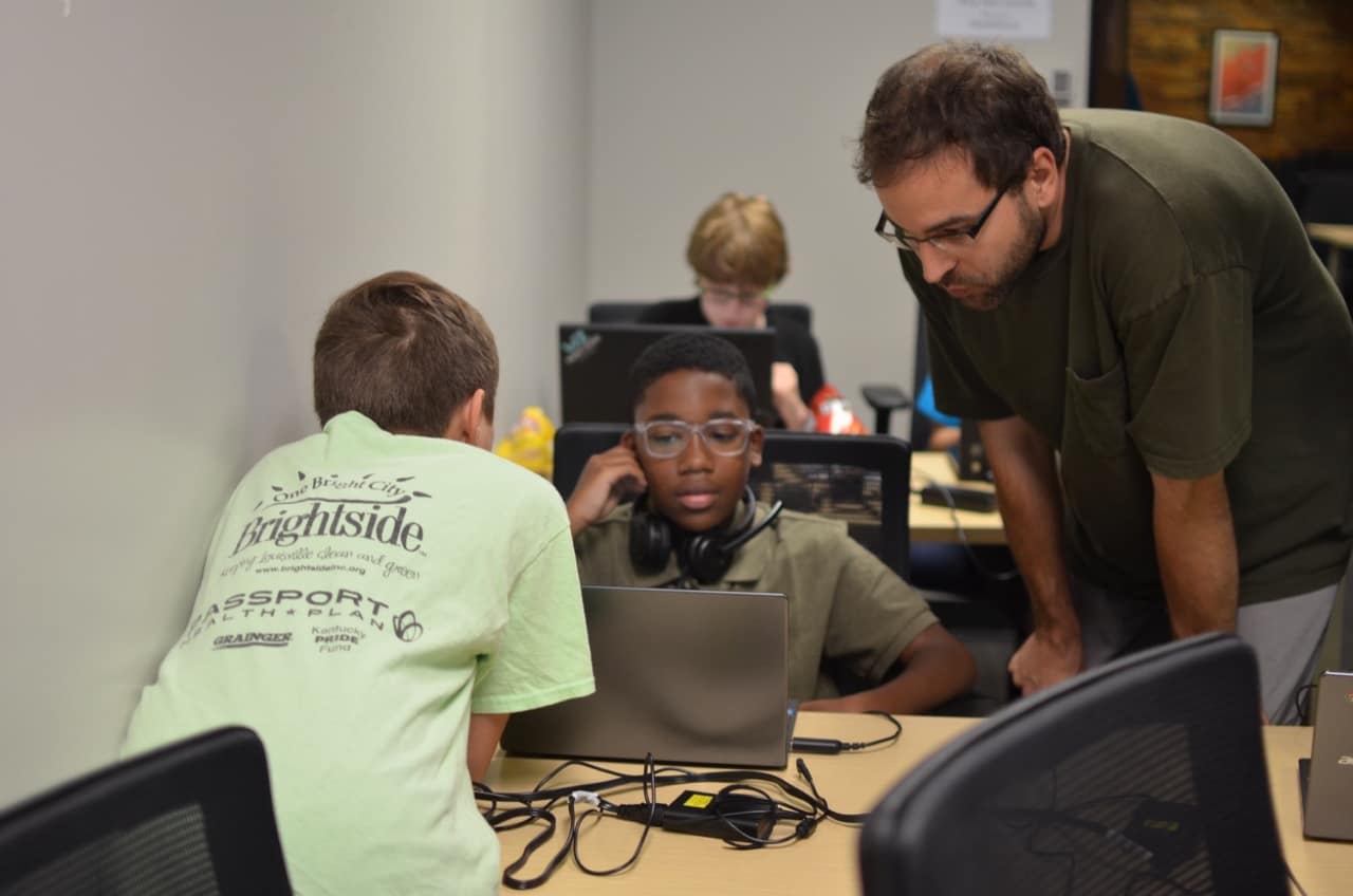 Students and an assistant providing help